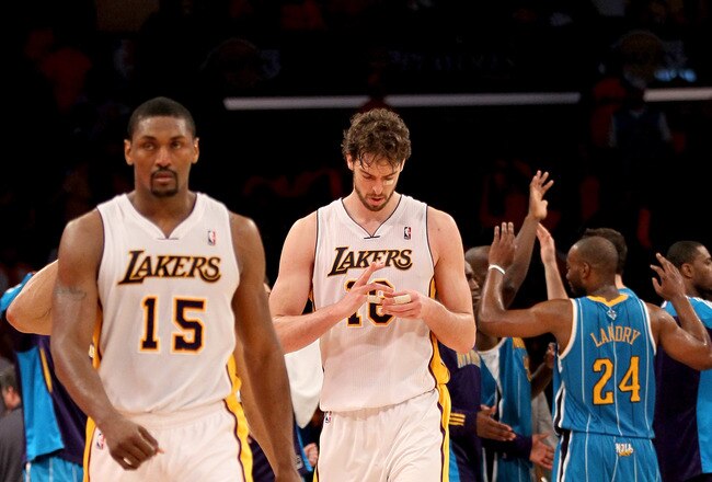LOS ANGELES, CA - APRIL 17: Pau Gasol #16 and Ron Artest of the Los Angeles Lakers walk off the court as the New Orleans Hornets celebrate after Game One of the Western Conference Quarterfinals in the 2011 NBA Playoffs on April 17, 2011 at Staples Center in Los Angeles, California.  The Hornets won 109-100.  NOTE TO USER: User expressly acknowledges and agrees that, by downloading and or using this photograph, User is consenting to the terms and conditions of the Getty Images License Agreement.  (Photo by Stephen Dunn/Getty Images)