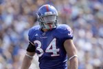 LAWRENCE, KS - SEPTEMBER 19:  Linebacker Huldon Tharp #34 of the Kansas Jayhawks gets ready on the line during the game against the Duke Blue Devils on Kivisto Field at Memorial Stadium on September 19, 2009 in Lawrence, Kansas. (Photo by Jamie Squire/Getty Images)