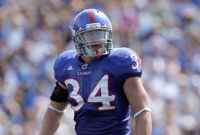 LAWRENCE, KS - SEPTEMBER 19:  Linebacker Huldon Tharp #34 of the Kansas Jayhawks gets ready on the line during the game against the Duke Blue Devils on Kivisto Field at Memorial Stadium on September 19, 2009 in Lawrence, Kansas. (Photo by Jamie Squire/Getty Images)