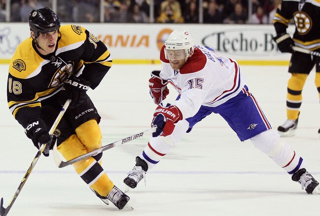 BOSTON, MA - MARCH 24:  Nathan Horton #18 of the Boston Bruins takes the puck as Jeff Halpern #15 of the Montreal Canadiens defends on March 24, 2011 at the TD Garden in Boston, Massachusetts.  (Photo by Elsa/Getty Images)