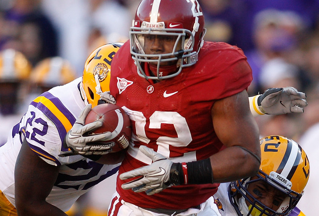 BATON ROUGE, LA - NOVEMBER 06:  Mark Ingram #22 of the Alabama Crimson Tide is tackled by Eric Reid #1 and Ryan Baker #22 of the Louisiana State University Tigers at Tiger Stadium on November 6, 2010 in Baton Rouge, Louisiana.  The Tigers defeated the Crimson Tide 24-21.  (Photo by Chris Graythen/Getty Images)