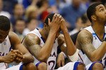 SAN ANTONIO, TX - MARCH 27:  (L-R) Thomas Robinson #0, Marcus Morris #22, Markieff Morris #21 of the Kansas Jayhawks react during the southwest regional final of the 2011 NCAA men's basketball tournament at the Alamodome on March 27, 2011 in San Antonio, Texas. Virginia Commonwealth defeated Kansas 71-61. (Photo by Ronald Martinez/Getty Images)