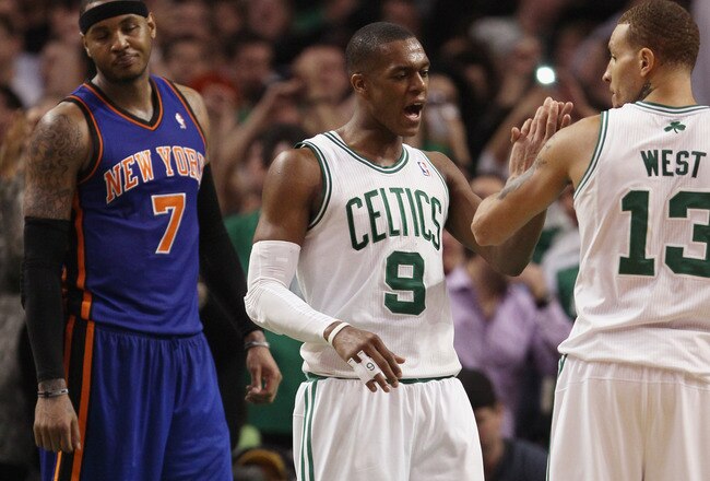BOSTON, MA - APRIL 19:  Rajon Rondo #9 of the Boston Celtics congratulates Delonte West #13 after he made a free throw with .6 seconds left in the game as Carmelo Anthony #7 of the New York Knicks reacts in Game Two of the Eastern Conference Quarterfinals in the 2011 NBA Playoffs on April 19, 2011 at the TD Garden in Boston, Massachusetts. The Boston Celtics defeated the New York Knicks 96-93. NOTE TO USER: User expressly acknowledges and agrees that, by downloading and or using this photograph, User is consenting to the terms and conditions of the Getty Images License Agreement.  (Photo by Elsa/Getty Images)