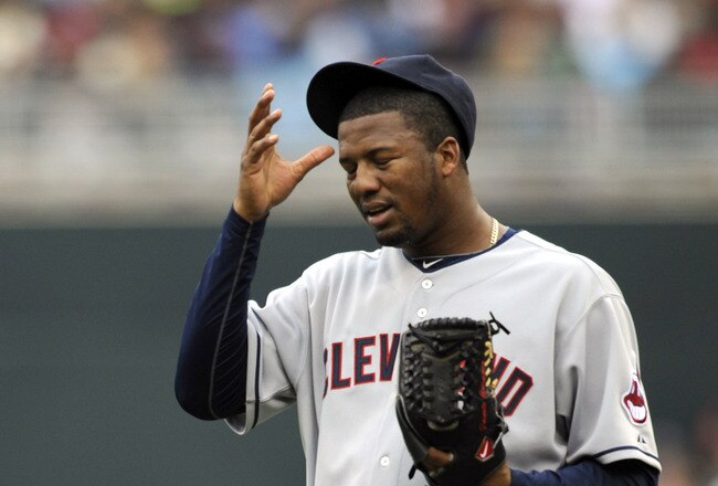 MINNEAPOLIS, MN - APRIL 23: Fausto Carmona #55 of the Cleveland Indians reacts to a wild pitch advancing a runner from second base to third base against the Minnesota Twins during the third inning of their game on April 23, 2011 at Target Field in Minneapolis, Minnesota. (Photo by Hannah Foslien/Getty Images)