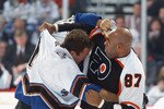 WASHINGTON - NOVEMBER 9:  Stephen Peat #51 of the Washington Capitals and Donald Brashear #87 of the Philadelphia Flyers mix it up during the first period of the NHL game on November 9, 2002 at the MCI Center in Washington D.C. (Photo by Doug Pensinger/Getty Images)