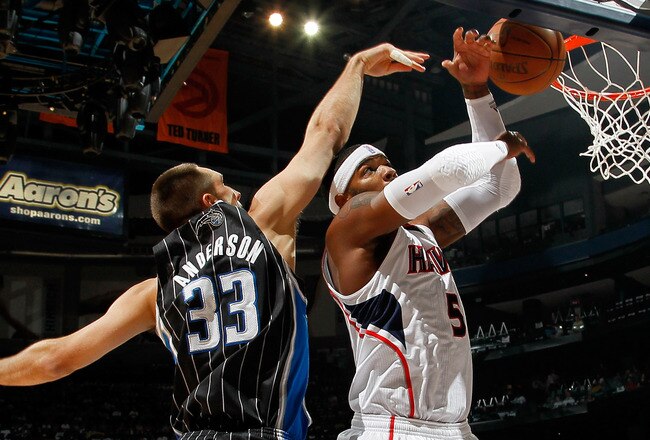 ATLANTA, GA - APRIL 24:  Josh Smith #5 of the Atlanta Hawks grabs a rebound against Ryan Anderson #33 of the Orlando Magic during Game Four of the Eastern Conference Quarterfinals in the 2011 NBA Playoffs at Philips Arena on April 24, 2011 in Atlanta, Georgia.  NOTE TO USER: User expressly acknowledges and agrees that, by downloading and or using this photograph, User is consenting to the terms and conditions of the Getty Images License Agreement.  (Photo by Kevin C. Cox/Getty Images)