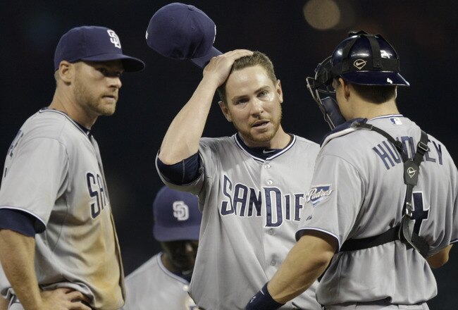HOUSTON - APRIL 14:  Pitcher Dustin Moseley of the San Diego Padres,center, wipes his head as he talks with catcher Nick Hundley, right, and Chase Headley , left  at Minute Maid Park on April 14, 2011 in Houston, Texas.  (Photo by Bob Levey/Getty Images)