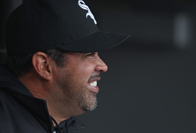 CHICAGO, IL - APRIL 07: Manager Ozzie Guillen #13 of the Chicago White Sox sits in the dugout before the home opener against the Tampa Bay Rays at U.S. Cellular Field on April 7, 2011 in Chicago, Illinois. The White Sox defeated the Rays 5-1. (Photo by Jonathan Daniel/Getty Images)