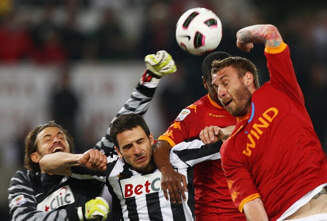 ROME, ITALY - APRIL 03: Fabio Grosso (C) and goalkeeper Marco Storari (L) of Juventus FC compete for the ball with Daniele De Rossi of AS Roma during the Serie A match between AS Roma and Juventus FC at Stadio Olimpico on April 3, 2011 in Rome, Italy.  (Photo by Paolo Bruno/Getty Images)