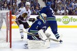 VANCOUVER, CANADA - APRIL 26: Goalie Roberto Luongo #1of the Vancouver Canucks  makes a save while Kevin Bieksa #3 of the Vancouver Canucks and Jonathan Toews #19 of the Chicago Blackhawks battle for position during the second period in Game Seven of the Western Conference Quarterfinals during the 2011 NHL Stanley Cup Playoffs on April 26, 2011 at Rogers Arena in Vancouver, BC, Canada.  (Photo by Rich Lam/Getty Images)