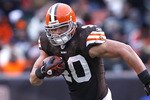 CLEVELAND - DECEMBER 26:  Tailback Peyton Hillis #40 of the Cleveland Browns runs the ball by linebacker Terrell Suggs #55 of the Baltimore Ravens at Cleveland Browns Stadium on December 26, 2010 in Cleveland, Ohio.  (Photo by Matt Sullivan/Getty Images)