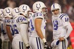 FOXBORO, MA - JANUARY 16:  Quarterback Peyton Manning #18 of the Indianapolis Colts talks with teammates during the AFC divisional playoff game against  the New England Patriots at Gillette Stadium on January 16, 2005 in Foxboro, Massachusetts.  The Patriots defeated the Colts 20-3.  (Photo By Elsa/Getty Images)