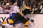 BOSTON, MA - APRIL 27:   Johnny Boychuk #55 of the Boston Bruins slams Jeff Halpern #15 of the Montreal Canadiens into the boards in Game Seven of the Eastern Conference Quarterfinals during the 2011 NHL Stanley Cup Playoffs at TD Garden on April 27, 2011 in Boston, Massachusetts.  (Photo by Jim Rogash/Getty Images)