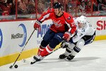 WASHINGTON - NOVEMBER 26:  Brett Clark #7 of the Tampa Bay Lightning battles for the puck against Jason Chimera #25 of the Washington Capitals at the Verizon Center on November 26, 2010 in Washington, DC.  (Photo by Greg Fiume/Getty Images)