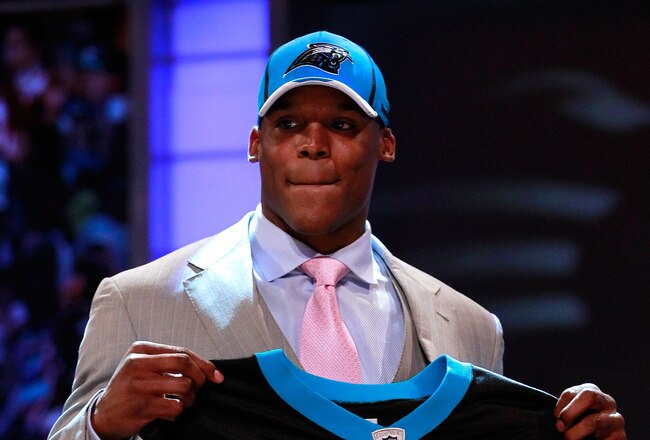NEW YORK, NY - APRIL 28:  Cam Newton, #1 overall pick by the Carolina Panthers holds up a jersey on stage after he was picked during the 2011 NFL Draft at Radio City Music Hall on April 28, 2011 in New York City.  (Photo by Chris Trotman/Getty Images)