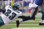 EAST RUTHERFORD, NJ - DECEMBER 19:  Mario Manningham #82 of the New York Giants turns out of the tackle of Dimitri Patterson #23 of the Philadelphia Eagles on his way to a touchdown at New Meadowlands Stadium on December 19, 2010 in East Rutherford, New Jersey.  (Photo by Nick Laham/Getty Images)