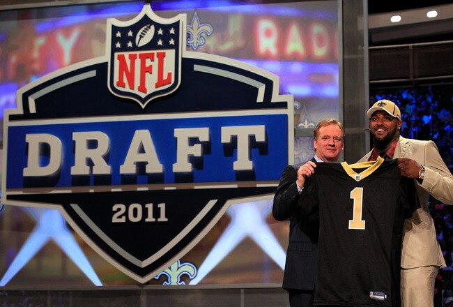 NEW YORK, NY - APRIL 28:  NFL Commissioner Roger Goodell (L) poses for a photo with Cameron Jordan, #24 overall pick by the New Orleans Saints, holds up a jersey on stage during the 2011 NFL Draft at Radio City Music Hall on April 28, 2011 in New York City.  (Photo by Chris Trotman/Getty Images)