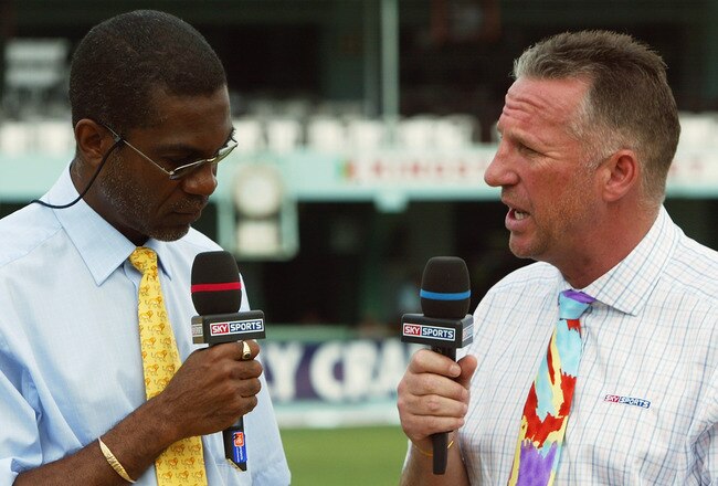 KINGSTON, JAMAICA - MARCH 13:  Sky Sports commentators Ian Botham (R) and Michael Holding talk before the start of play during the Cable and Wireless First Test match between West Indies and England at the Sabina Park Cricket Ground on March 13, 2004 in Kingston, Jamaica. (Photo by Ben Radford/Getty Images)
