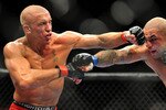 LAS VEGAS - JULY 11:  (L-R) Georges St. Pierre battles Thiago Alves during their welterweight title bout during UFC 100 on July 11, 2009 in Las Vegas, Nevada.  (Photo by Jon Kopaloff/Getty Images)