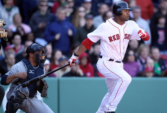 BOSTON, MA - MAY 01:  Carl Crawford #13 of the Boston Red Sox drives in the game winning run as Miguel Olivo #30 of the Seattle Mariners defends on May 1, 2011 at Fenway Park in Boston, Massachusetts. The Boston Red Sox defeated the Seattle Mariners 3-2.  (Photo by Elsa/Getty Images)
