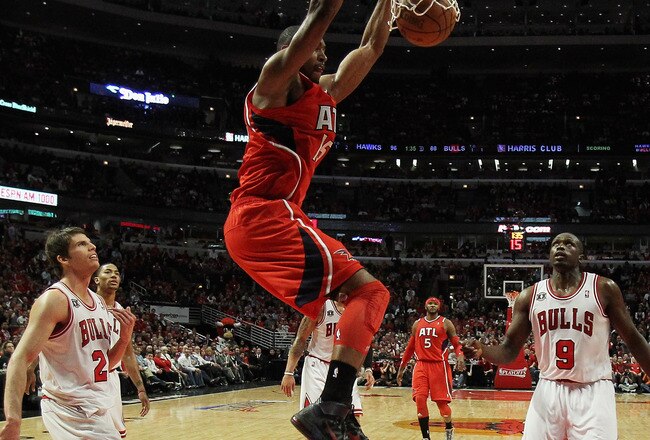 CHICAGO, IL - MAY 02: Al Horford #15 of the Atlanta Hawks dunks the ball over Kyle Korver #26 and Loul Deng #9 of the Chicago Bulls in Game One of the Eastern Conference Semifinals in the 2011 NBA Playoffs at the United Center on May 2, 2011 in Chicago, Illinois. The Hawks defeated the Bulls 103-95. NOTE TO USER: User expressly acknowledges and agrees that, by downloading and/or using this photograph, User is consenting to the terms and conditions of the Getty Images License Agreement. (Photo by Jonathan Daniel/Getty Images)