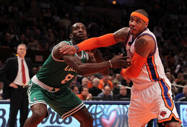 NEW YORK, NY - APRIL 22:  Carmelo Anthony #7 of the New York Knicks fights for rebound position against Jeff Green #8 of the Boston Celtics as Knicks head coach Mike D'Antoni (L) in the first half of Game Three of the Eastern Conference Quarterfinals in the 2011 NBA Playoffs on April 22, 2011 at Madison Square Garden in New York City.  NOTE TO USER: User expressly acknowledges and agrees that, by downloading and or using this photograph, User is consenting to the terms and conditions of the Getty Images License Agreement.  (Photo by Nick Laham/Getty Images)