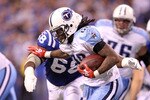 INDIANAPOLIS - JANUARY 02:  Chris Johnson #28 of the Tennessee Titans is tackled by Eric Foster #68 of the Indianapolis Colts at Lucas Oil Stadium on January 2, 2011 in Indianapolis, Indiana.  the Colts won 23-20.  (Photo by Andy Lyons/Getty Images)
