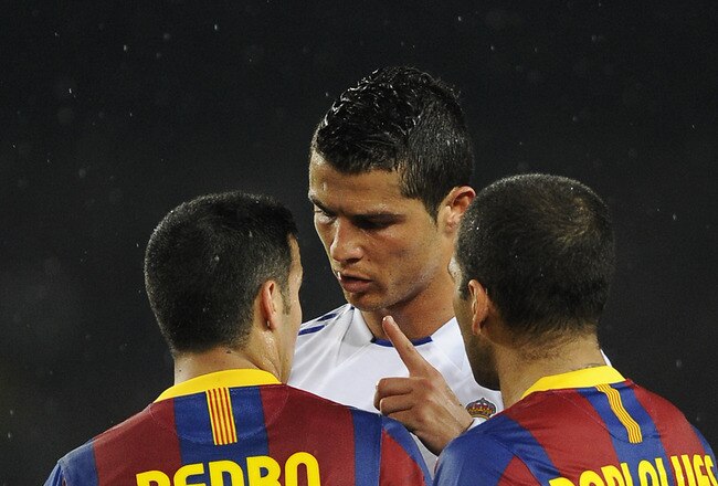 BARCELONA, SPAIN - MAY 03:  Cristiano Ronaldo of Real Madrid (C) argues with Pedro Rodriguez (L) and Dani Alves of FC Barcelona during the UEFA Champions League Semi Final second leg match between Barcelona and Real Madrid at the Camp Nou on May 3, 2011 in Barcelona, Spain.  (Photo by David Ramos/Getty Images)