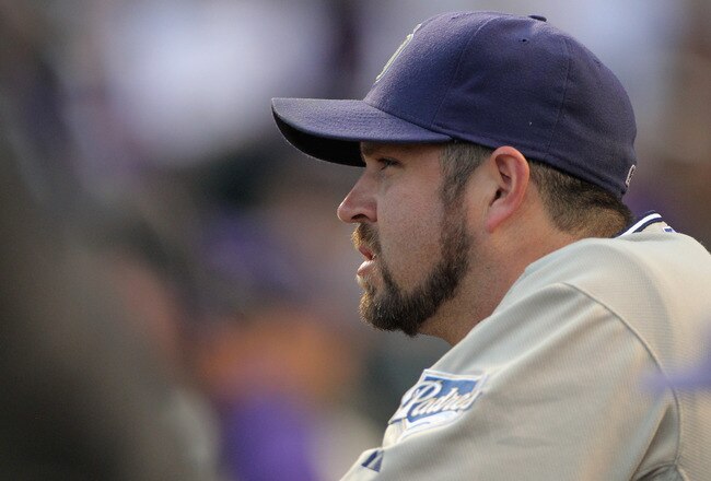 DENVER - SEPTEMBER 14:  Relief pitcher Heath Bell #21 of the San Diego Padres looks on from the dugout prior to facing the Colorado Rockies at Coors Field on September 14, 2010 in Denver, Colorado. Bell recorded his 42nd save as the Padres defeated the Rockies 7-6.  (Photo by Doug Pensinger/Getty Images)