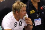 MELBOURNE, AUSTRALIA - JANUARY 23:  Former Australian cricketer Shane Warne eats a Drumstick ice cream during the fourth round match between Andy Roddick of the United States of America and Stanislas Wawrinka of Switzerland during day seven of the 2011 Australian Open at Melbourne Park on January 23, 2011 in Melbourne, Australia.  (Photo by Cameron Spencer/Getty Images)