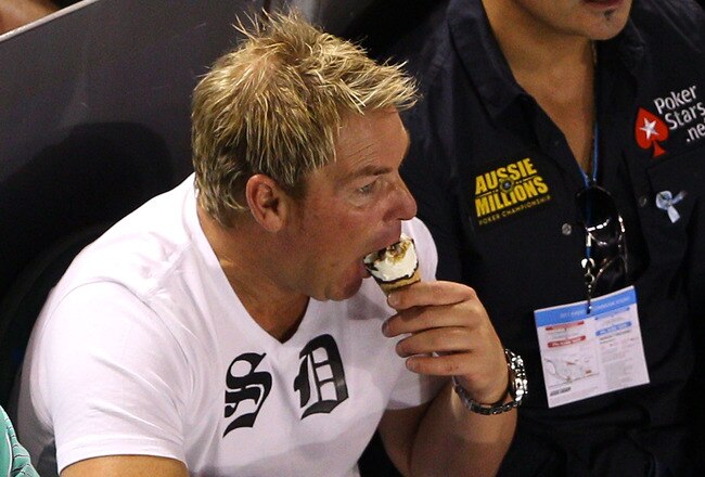 MELBOURNE, AUSTRALIA - JANUARY 23:  Former Australian cricketer Shane Warne eats a Drumstick ice cream during the fourth round match between Andy Roddick of the United States of America and Stanislas Wawrinka of Switzerland during day seven of the 2011 Australian Open at Melbourne Park on January 23, 2011 in Melbourne, Australia.  (Photo by Cameron Spencer/Getty Images)