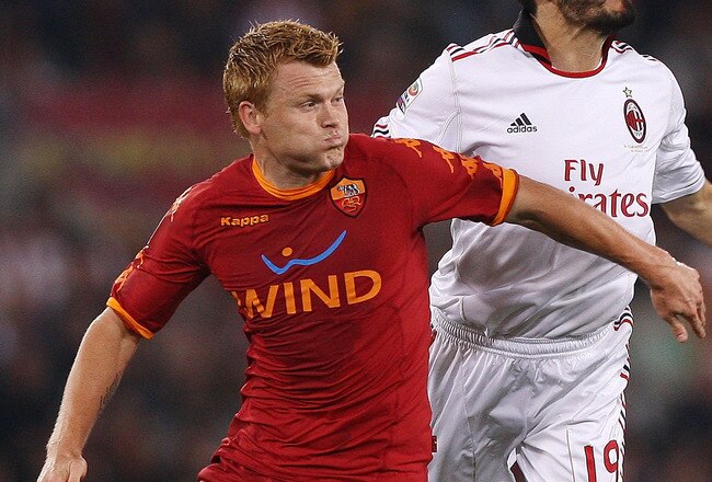 ROME, ITALY - MAY 07:  John Arne Riise of AS Roma and Christian Zambrotta (R) of AC Milan in action during the Serie A match between AS Roma and AC Milan at Stadio Olimpico on May 7, 2011 in Rome, Italy.  (Photo by Paolo Bruno/Getty Images)