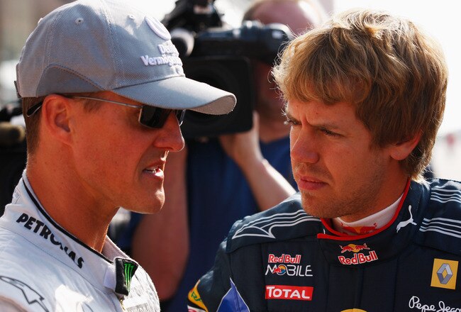 YEONGAM GUN, SOUTH KOREA - OCTOBER 22:  (L-R) German F1 drivers Michael Schumacher of Mercedes GP and Sebastian Vettel of Red Bull Racing talk as they line up for a photograph before practice for the Korean Formula One Grand Prix at the Korea International Circuit on October 22, 2010 in Yeongam-gun, South Korea.  (Photo by Mark Thompson/Getty Images)