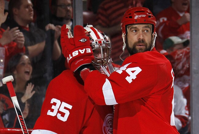 DETROIT - MAY 6: Todd Bertuzzi #44 of the Detroit Red Wings celebrates a 4-3 win over the San Jose Sharks with Jimmy Howard #35 in Game Four of the Western Conference Semifinals during the 2011 NHL Stanley Cup Playoffs on May 6, 2011 at Joe Louis Arena in Detroit, Michigan. San Jose leads the series 3-1. (Photo by Gregory Shamus/Getty Images)