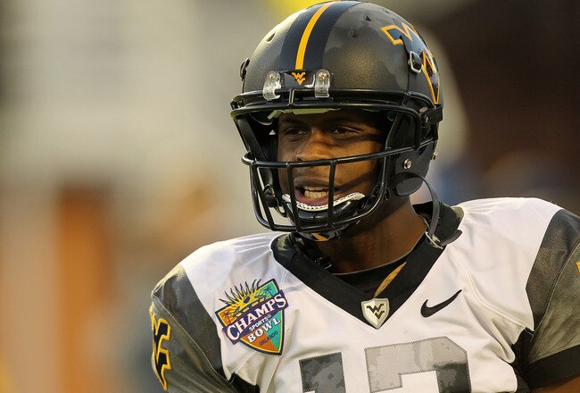 ORLANDO, FL - DECEMBER 28: Geno Smith #12 of the West Virginia Mountineers warms up during the Champs Sports Bowl against the North Carolina State Wolfpack at Florida Citrus Bowl Stadium on December 28, 2010 in Orlando, Florida.  (Photo by Mike Ehrmann/Getty Images)
