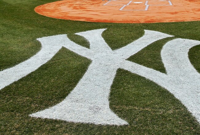 NEW YORK, NY - MARCH 31:  The New York Yankees and the Detroit Tigers look on as West Point Cadets unfurl the American Flag during the opening ceremonies on Opening Day at Yankee Stadium on March 31, 2011 in Bronx borough of New York City.  (Photo by Nick Laham/Getty Images)