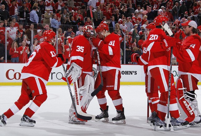DETROIT - MAY 10: Jimmy Howard #35 of the Detroit Red Wings celebrates a 3-1 victory with teammates over the San Jose Sharks in Game Six of the Western Conference Semifinals during the 2011 NHL Stanley Cup Playoffs on May 10, 2011 at Joe Louis Arena in Detroit, Michigan. (Photo by Gregory Shamus/Getty Images)