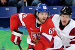 VANCOUVER, BC - FEBRUARY 23:  Jaromir Jagr #68 of Czech Republic is pursued by Janis Sprukts #5 of Latvia during the ice hockey Men's Play-off qualification match between the Czech Republic and Latvia on day 12 of the Vancouver 2010 Winter Olympics at UBC Thunderbird Arena on February 23, 2010 in Vancouver, Canada.  (Photo by Harry How/Getty Images)