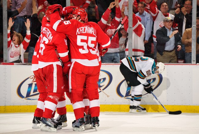 DETROIT - MAY 4:  The Detroit Red Wings celebrate a second period power play goal by Pavel Datsyuk #13 of the Detroit Red Wings as Dan Boyle #22 of the San Jose Sharks skates by in Game Three of the Western Conference Semifinals during the 2011 NHL Stanley Cup Playoffs on May 4, 2011 at Joe Louis Arena in Detroit, Michigan.  (Photo by Jamie Sabau/Getty Images)