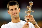 MADRID, SPAIN - MAY 08:  Novak Djokovic of Serbia holds the Ion Tiriac's trophy aloft after winning his final match against Rafael Nadal of Spain in straight sets during day eight of the Mutua Madrilena Madrid Open Tennis on May 8, 2011 in Madrid, Spain.  (Photo by Jasper Juinen/Getty Images)