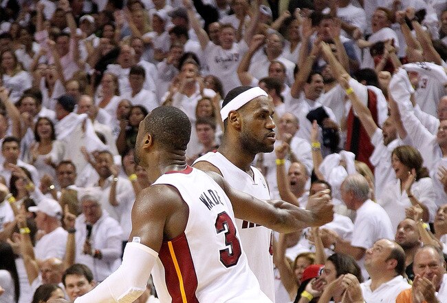 MIAMI, FL - MAY 11:  LeBron James #6 of the Miami Heat is congratulated by Dwyane Wade #3 during Game Five of the Eastern Conference Semifinals of the 2011 NBA Playoffs against the Boston Celtics at American Airlines Arena on May 11, 2011 in Miami, Florida. NOTE TO USER: User expressly acknowledges and agrees that, by downloading and/or using this Photograph, User is consenting to the terms and conditions of the Getty Images License Agreement.  (Photo by Mike Ehrmann/Getty Images)