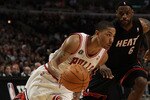 CHICAGO, IL - FEBRUARY 24: Derrick Rose #1 of the Chicago Bulls drives past LeBron James #6 of the Miami Heat at the United Center on February 24, 2011 in Chicago, Illinois. The Bulls defeated the Heat 93-89. NOTE TO USER: User expressly acknowledges and agrees that, by downloading and/or using this photograph, User is consenting to the terms and conditions of the Getty Images License Agreement.  (Photo by Jonathan Daniel/Getty Images)