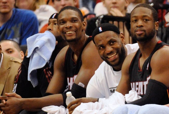MINNEAPOLIS, MN - APRIL 1: Chris Bosh #1, LeBron James #6 and Dwyane Wade #3 of the Miami Heat sit on the bench in the final minutes of a basketball game against the Minnesota Timberwolves at Target Center on April 1, 2011 in Minneapolis, Minnesota. Heat defeated the Timberwolves 111- 92. NOTE TO USER: User expressly acknowledges and agrees that, by downloading and or using this Photograph, user is consenting to the terms and conditions of the Getty Images License Agreement.  (Photo by Hannah Foslien /Getty Images)