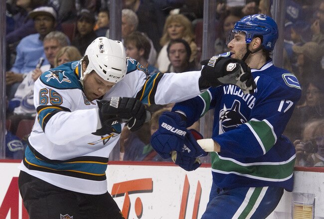 VANCOUVER, CANADA - JANUARY 20: Ryan Kesler #17 of the Vancouver Canucks and Derek Joslin #65 of the San Jose Sharks push and shove behind the play during the second period in NHL action on January 20, 2011 at Rogers Arena in Vancouver, BC, Canada.  (Photo by Rich Lam/Getty Images)