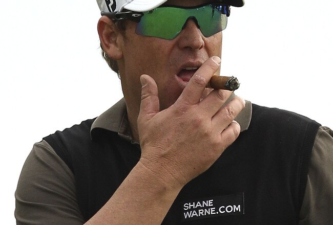 MELBOURNE, AUSTRALIA - NOVEMBER 10:  Shane Warne of Australia smokes a cigar during the Pro-Am ahead of the Australian Masters at The Victoria Golf Club on November 10, 2010 in Melbourne, Australia.  (Photo by Lucas Dawson/Getty Images)