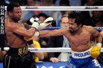LAS VEGAS, NV - MAY 07: Manny Pacquiao (R) throws a right at Shane Mosley in the sixth round of their WBO welterweight title fight at the MGM Grand Garden Arena May 7, 2011 in Las Vegas, Nevada. Pacquiao retained his title with a unanimous-decision victory. (Photo by Ethan Miller/Getty Images)