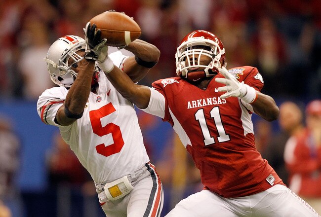NEW ORLEANS, LA - JANUARY 04:  Chimdi Chekwa #5 of the Ohio State Buckeyes is unable to come up with an interception as he goes up for the ball against Cobi Hamilton #11 of the Arkansas Razorbacks in the second quarter during the Allstate Sugar Bowl at the Louisiana Superdome on January 4, 2011 in New Orleans, Louisiana. Chekwa was injured on the play. (Photo by Matthew Stockman/Getty Images)
