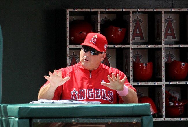 ANAHEIM, CA - MAY 08:  Manager Mike Scioscia of the Los Angeles Angels of Anaheim signals during the game against the Cleveland Indians on May 8, 2011 at Angel Stadium in Anaheim, California.  The win was Scoiscia's 1,000th  career victory as a manager as the Angels won 6-5.  (Photo by Stephen Dunn/Getty Images)