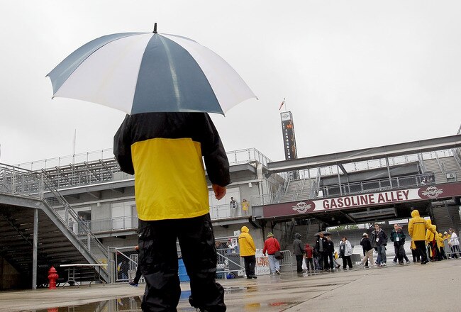 INDIANAPOLIS, IN - MAY 15:  Safety guards patrol the famed Gasoline Alley as rain interupts the first day of practice for the Indianapolis 500 at Indianapolis Motor Speedway on May 15, 2011 in Indianapolis, Indiana.  (Photo by Matthew Stockman/Getty Images)