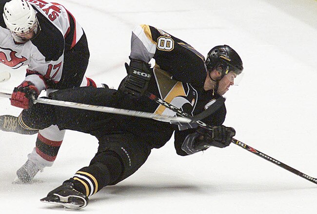 12 May 2001:   Petr Sykora #17 of the New Jersey Devils upends Jaromir Jagr #68 of the Pittsburgh Penguins during the second period of Game 1 of the Eastern Conference Finals at Continental Airlines Arena at the Meadowlands in East Rutherford, New Jersey.   Digital Image. Mandatory Credit: Jamie Squire/ALLSPORT